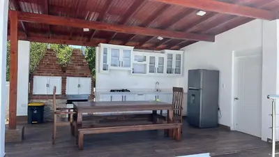 a kitchen with a wooden table and a refrigerator at Luxury Beach Front Villa with Private pool and stunning Ocean View! in Punta Rucia
