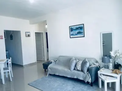 a living room with a couch and a table at A Caribbean-style rebirth, 2 minutes from the beach in La Romana
