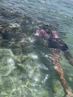 a person laying in the water in the ocean at A Caribbean-style rebirth, 2 minutes from the beach in La Romana