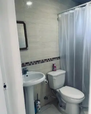 a bathroom with a toilet and a sink at A Caribbean-style rebirth, 2 minutes from the beach in La Romana