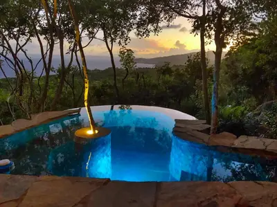 a swimming pool with a light in the middle at Casa El Paraiso, Eco Lodge in Santa Bárbara de Samaná