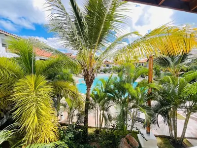 a view of a resort with palm trees and a pool at Bayahibe Paraíso in Bayahibe