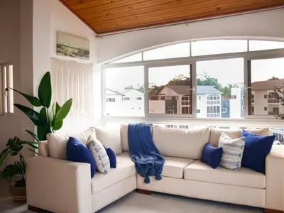 a white couch in a living room with a large window at Apartamento de Ensueño en Las Terrenas Penthouse in Las Terrenas
