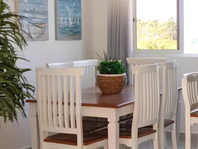 a dining room table and chairs with a potted plant at Apartamento de Ensueño en Las Terrenas Penthouse in Las Terrenas