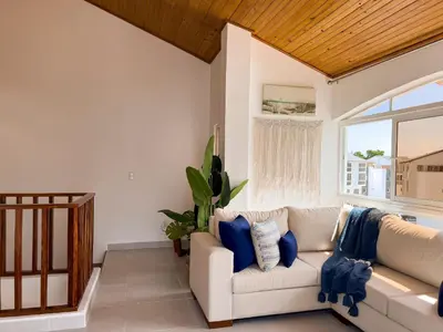 a living room with a white couch and a window at Apartamento de Ensueño en Las Terrenas Penthouse in Las Terrenas