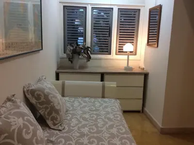 a living room with a couch and a table with windows at Caraibidamari in Bayahibe