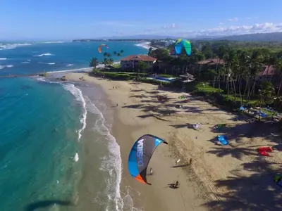 an aerial view of a beach with a kite at Mango House. Mono 2 bedrooms in Cabarete