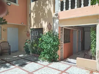 a building with plants on the side of it at Villa rozenuda in Boca Chica
