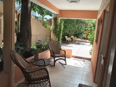 two chairs and a table on a patio at Villa rozenuda in Boca Chica