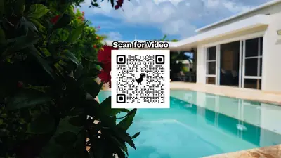 a house with a clock next to a swimming pool at Casa Linda Villa 920 - Sosua in Sosúa