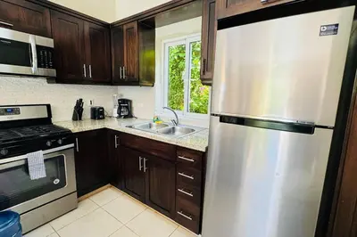 a kitchen with a stainless steel refrigerator and a sink at Casa Linda Villa 920 - Sosua in Sosúa