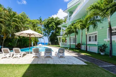 a patio with chairs and an umbrella next to a house at 