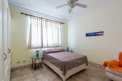 a bedroom with a bed and a ceiling fan at 