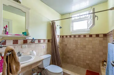 a bathroom with a toilet and a sink and a window at 
