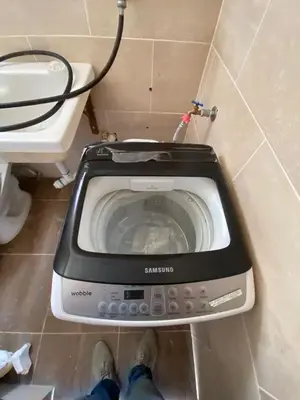 a washing machine in a bathroom next to a toilet at Estefany Aparment New in San Felipe de Puerto Plata