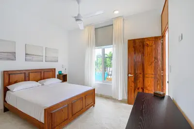 a bedroom with a large bed and a window at Enriquillo 2-Bedroom Apt Casa Areito in Santo Domingo