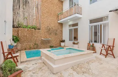 a swimming pool in the backyard of a building at Guacanagarix 2-Bedroom Apt Casaareito in Santo Domingo