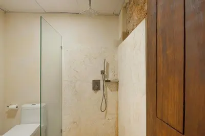 a bathroom with a shower with a glass door at Guacanagarix 2-Bedroom Apt Casaareito in Santo Domingo