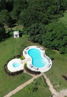 an overhead view of a swimming pool in a field at Margarita Ecovillage in Miches