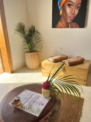 a room with a table with a picture of a woman at Margarita Ecovillage in Miches