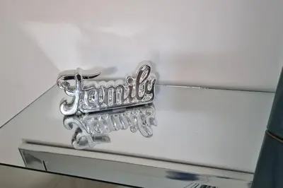 a chrome emblem on the front of a white car at Lujosa y espaciosa Villa María. in Santiago de los Caballeros