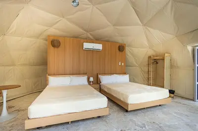 a room with two beds in a yurt at Bubble Glamping Sosua! in Sosúa