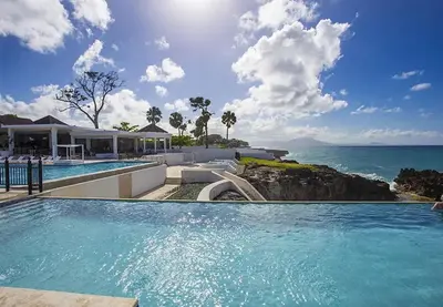 a swimming pool with a view of the ocean at Bubble Glamping Sosua! in Sosúa