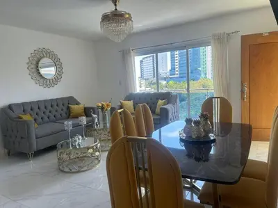 a living room with a dining table and a couch at Acogedor Sweet Apartament in Santiago de los Caballeros