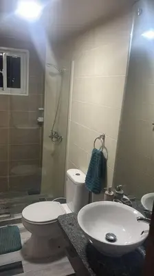 a bathroom with a toilet and a sink and a shower at Acogedor Sweet Apartament in Santiago de los Caballeros