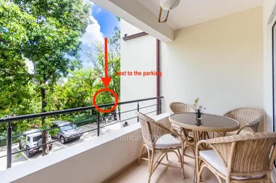 a balcony with a table and chairs and a window at Infiniti Blu, Sosua in Sosúa