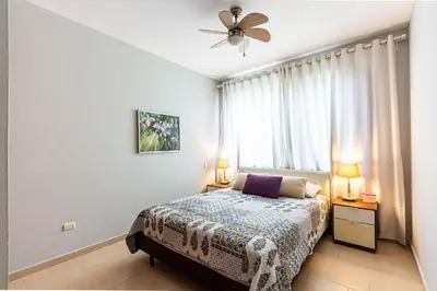 a bedroom with a bed and a ceiling fan at Infiniti Blu, Sosua in Sosúa