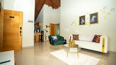 a living room with a couch and a chair at Luxury Sky Blue in Jarabacoa