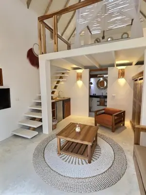a living room with a loft bed and a rug at Leeloo Boutique Hotel in Las Terrenas