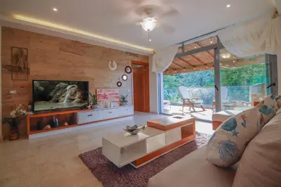 a living room with a couch and a tv at Villa loren A3 in Las Terrenas