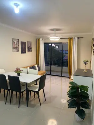 a living room with a table and chairs and a couch at Apartamento con agua caliente para 9 personas in La Ureña