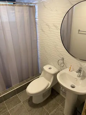 a bathroom with a toilet and a sink and a mirror at Apartamento con agua caliente para 9 personas in La Ureña