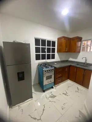a kitchen with a refrigerator and a stove at Residencial Doña Gloria 2 in San Felipe de Puerto Plata