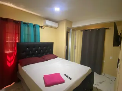 a bedroom with a bed with a pink towel on it at Residencial Doña Gloria 2 in San Felipe de Puerto Plata