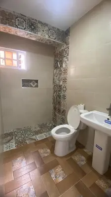 a bathroom with a toilet and a sink at Residencial Doña Gloria 2 in San Felipe de Puerto Plata
