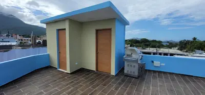 a small house on a balcony with a trash can at Residencial Doña Gloria 2 in San Felipe de Puerto Plata