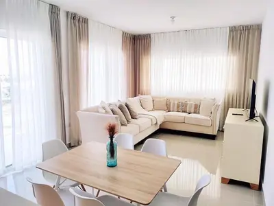 a living room with a couch and a table and chairs at Confortable Apartamento con Piscina en Cabrera in Cabrera