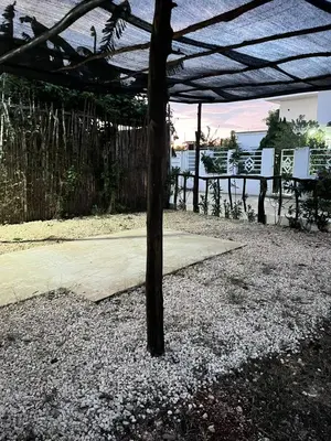 a wooden pergola with a table and a bench at Blue Beach Eco-Hotel by Sanfabini in Bayahibe