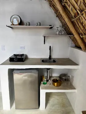 a small kitchen with a sink and a counter top at Blue Beach Eco-Hotel by Sanfabini in Bayahibe