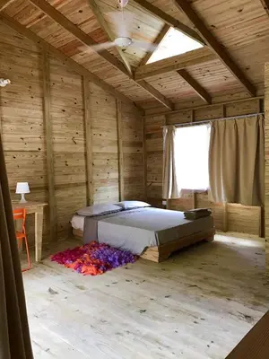 a bedroom with a bed in a wooden room at Mango House Camino laguna in Cabarete