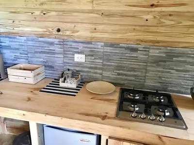 a kitchen with a stove and a wooden counter top at Mango House Camino laguna in Cabarete