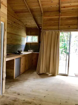 a kitchen with wooden walls and a large window at Mango House Camino laguna in Cabarete