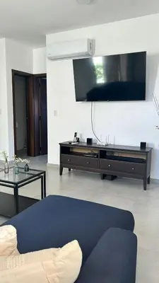 a living room with a couch and a tv at Moderno y acogedor apartamento in Santo Domingo