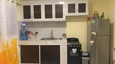 a kitchen with a sink and a refrigerator at Guest House A&H in Boca Chica