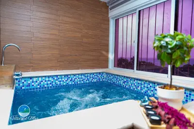 a swimming pool in a room with a window at Villa del Mar in Santa Cruz de Barahona