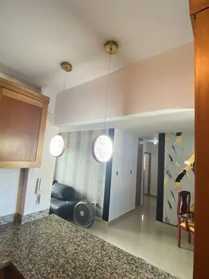 a living room with two pendant lights and a couch at Luxury Penthouse Santo Domingo W in Santo Domingo